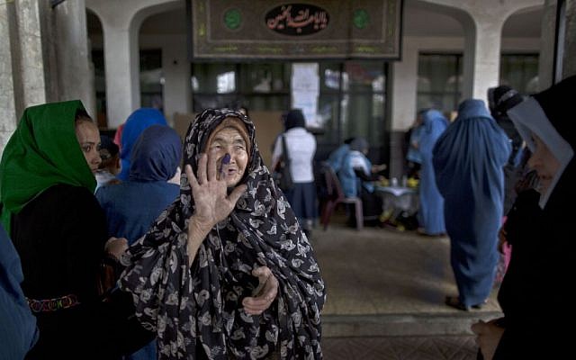 An elderly Afghan woman shows another woman her inked finger after casting her ballot at a polling station in Kabul, Afghanistan, Saturday, on April 5, 2014. (photo credit: AP Photo/Muhammed Muheisen) An elderly Afghan woman shows another woman her inked finger after casting her ballot at a polling station in Kabul, Afghanistan, Saturday, on April 5, 2014. (photo credit: AP Photo/Muhammed Muheisen)