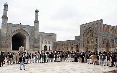 Afghan men line up before casting their votes at a polling station in Herat, Afghanistan, Saturday, April 5, 2014. (photo credit: AP Photo/Hoshang Hashimi)