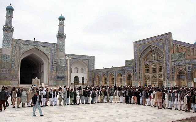 Afghan men line up before casting their votes at a polling station in Herat, Afghanistan, Saturday, April 5, 2014. (photo credit: AP Photo/Hoshang Hashimi) Afghan men line up before casting their votes at a polling station in Herat, Afghanistan, Saturday, April 5, 2014. (photo credit: AP Photo/Hoshang Hashimi)