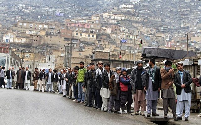 Afghan men line up outside a polling station to cast their ballots, in Kabul, Afghanistan, on Saturday, April 5, 2014. (photo credit: AP Photo/Rahmatullah Nikzad) Afghan men line up outside a polling station to cast their ballots, in Kabul, Afghanistan, on Saturday, April 5, 2014. (photo credit: AP Photo/Rahmatullah Nikzad)