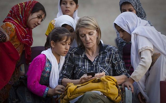 In this Saturday, Oct. 1, 2011 file photo, Associated Press Special Regional Correspondent for Afghanistan and Pakistan Kathy Gannon sits with girls at a school in Kandahar, Afghanistan. (photo credit: AP/Anja Niedringhaus, File)