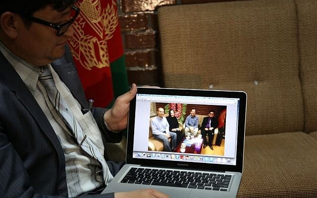 Mohammad Hadi Hadayati, Kabul University's vice chancellor shows a photograph, from left, slain American Jon Gabel, his mother, his father Gary Gabel, who was also killed, and himself, during an interview with the Associated Press in Kabul, Afghanistan, Saturday, April 26, 2014. An Afghan police security guard opened fire on foreigners, on Thursday, April 24, 2014, as they entered the grounds of Cure International Hospital, killing three people, including pediatrician Dr. Jerry Umanos of Chicago. On Saturday, Kabul University vice chancellor Mohammad Hadi Hadayati identified the other two Americans killed in the attack as health clinic administrator Jon Gabel and his visiting father, Gary, also from the Chicago area. Jon Gabel’s wife, also an American, was wounded, Hadayati said. “We have lost a great man, a great teacher, a man who was here only to serve the Afghan people,” Hadayati said. Jon Gabel worked for the U.S.-based charity Morning Star Development and ran a health clinic at Kabul University, teaching computer science classes in his spare time, Hadayati said. Jon Gabel’s parents were visiting from Chicago, and Hadayati had lunch with the whole family the day before the attack. (photo credit: AP photo/Rahmat Gul) Mohammad Hadi Hadayati, Kabul University's vice chancellor shows a photograph, from left, slain American Jon Gabel, his mother, his father Gary Gabel, who was also killed, and himself, during an interview with the Associated Press in Kabul, Afghanistan, Saturday, April 26, 2014. An Afghan police security guard opened fire on foreigners, on Thursday, April 24, 2014, as they entered the grounds of Cure International Hospital, killing three people, including pediatrician Dr. Jerry Umanos of Chicago. On Saturday, Kabul University vice chancellor Mohammad Hadi Hadayati identified the other two Americans killed in the attack as health clinic administrator Jon Gabel and his visiting father, Gary, also from the Chicago area. Jon Gabel’s wife, also an American, was wounded, Hadayati said. “We have lost a great man, a great teacher, a man who was here only to serve the Afghan people,” Hadayati said. Jon Gabel worked for the U.S.-based charity Morning Star Development and ran a health clinic at Kabul University, teaching computer science classes in his spare time, Hadayati said. Jon Gabel’s parents were visiting from Chicago, and Hadayati had lunch with the whole family the day before the attack. (photo credit: AP photo/Rahmat Gul)