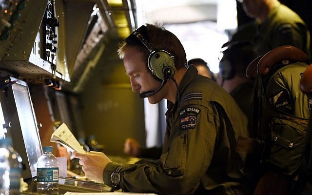 Flight Lieutenant Stephen Graham studies notes aboard a Royal New Zealand Air Force (RNZAF) P-3 Orion on route to search over the southern Indian Ocean looking for debris from missing Malaysia Airlines flight MH370 Friday, April 11, 2014. (AP Photo/Richard Polden) Flight Lieutenant Stephen Graham studies notes aboard a Royal New Zealand Air Force (RNZAF) P-3 Orion on route to search over the southern Indian Ocean looking for debris from missing Malaysia Airlines flight MH370 Friday, April 11, 2014. (AP Photo/Richard Polden)