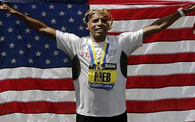 Meb Keflezighi, of San Diego, California, celebrates his victory with an American flag after the 118th Boston Marathon, on Monday, April 21, 2014 (photo credit: AP/Charles Krupa) Meb Keflezighi, of San Diego, California, celebrates his victory with an American flag after the 118th Boston Marathon, on Monday, April 21, 2014 (photo credit: AP/Charles Krupa)