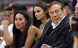Los Angeles Clippers owner Donald Sterling, right, and V. Stiviano, left, watch the Clippers play the Sacramento Kings in Los Angeles in October, 2013.  (photo credit: AP/Mark J. Terrill)