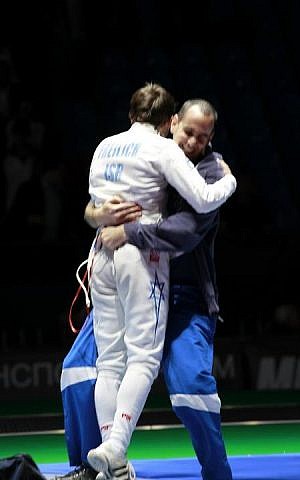 Yuval Freilich's coach, Ohad Balva of the Kfar Saba Fencing Club, hugs the teenager after his victory at the 2012 Cadet World Championships in Moscow (Photo courtesy of Rachel Freilich) Yuval Freilich's coach, Ohad Balva of the Kfar Saba Fencing Club, hugs the teenager after his victory at the 2012 Cadet World Championships in Moscow (Photo courtesy of Rachel Freilich)