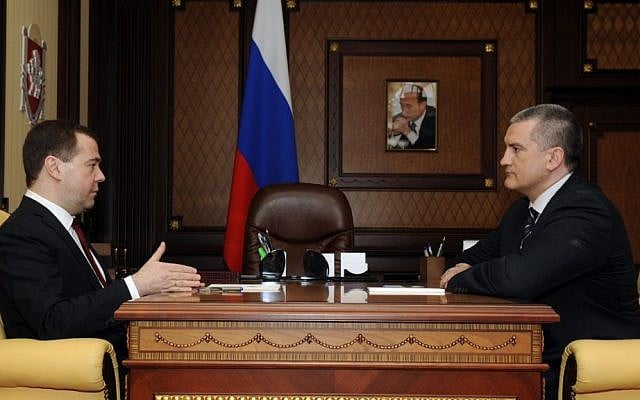 Russian Prime Minister Dmitry Medvedev, left, speaks to Crimean Premier Sergei Aksyonov while visiting Crimea in Simferopol, Crimea, Monday, March 31, 2014. (AP Photo/Alexandr Polegenko) Russian Prime Minister Dmitry Medvedev, left, speaks to Crimean Premier Sergei Aksyonov while visiting Crimea in Simferopol, Crimea, Monday, March 31, 2014. (AP Photo/Alexandr Polegenko)