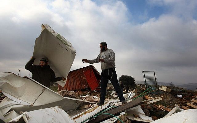 Settlers clean up after a home demolition in the illegal outpost of Mitzpeh Yitzhar, near Yitzhar, in 2011. (photo credit: Kobi Gideon / Flash90.)