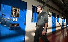 A guard is seen in an Israeli prison holding Palestinian prisoners (Moshe Shai/Flash90/File)