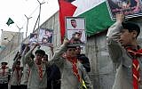 Palestinian youth hold placards during a solidarity rally for Palestinian prisoners in Israeli jails, organized by Hamas, in the Shuafat refugee camp, Jerusalem on April 19, 2013. (photo credit: Sliman Khader/Flash90)