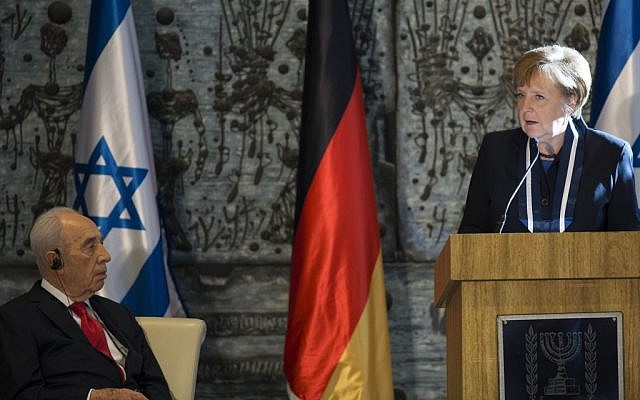 President Shimon Peres listens to German Chancellor Angela Merkel at the president's residence in Jerusalem, February 25, 2014. (Photo credit: Yonatan Sindel/Flash90)