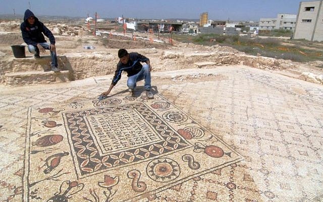 A man unveils Greek inscriptions as he cleans a Byzantine mosaic floor that decorated a monastery and that was discovered during infrastructure work in the Bedouin village of Hura, Tuesday, April 1, 2014. (photo credit: Flash90) A man unveils Greek inscriptions as he cleans a Byzantine mosaic floor that decorated a monastery and that was discovered during infrastructure work in the Bedouin village of Hura, Tuesday, April 1, 2014. (photo credit: Flash90)