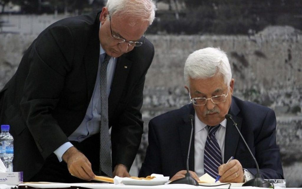 Palestinian Authority President Mahmoud Abbas, right, signs a request to join 15 United Nations-linked and other international treaties at his headquarters in the West Bank city of Ramallah on Tuesday, April 1, 2014. Standing next to him is Saeb Erekat. (Issam Rimawi/Flash90) Palestinian Authority President Mahmoud Abbas, right, signs a request to join 15 United Nations-linked and other international treaties at his headquarters in the West Bank city of Ramallah on Tuesday, April 1, 2014. Standing next to him is Saeb Erekat. (Issam Rimawi/Flash90)