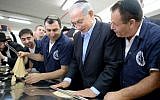 Prime Minister Benjamin Netanyahu seen during a visit at a matzah factory in Kfar Chabad, prior to the upcoming Jewish holiday of Passover,  April 1, 2014. (Photo credit: Kobi Gideon/ GPO/FLASH90)