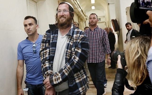 One of the Jewish settlers arrested for destroying an IDF outpost in the Israel settlement of Yitzhar is brought to the Tel Aviv Magistrate's Court on April 10, 2014. (photo credit: Miriam Alster/FLASH90)