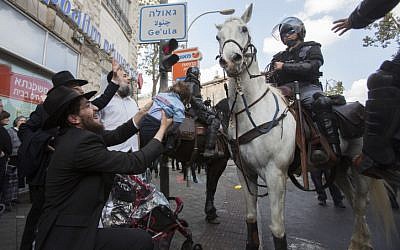 Hundreds of ultra-Orthodox Jews clash with police during a protest following the arrest of a draft-dodger, Jerusalem, April 10, 2014. (photo credit: Yonatan Sindel/Flash90)