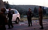 Troops next to the scene of a fatal shooting attack near Hebron on Monday, April 14, 2014. (photo credit:  Issam Rimawi/Flash90)