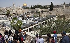 The Western Wall plaza with the Temple Mount in the background, as thousands of visitors arrive in the Old City of Jerusalem during the Jewish holiday of Passover, April 16, 2014. (photo credit: Flash90)