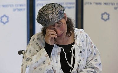 Hadas Mizrahi, wife of Baruch Mizrahi, 47, who was shot dead while driving on a road near Hebron in the West Bank on Monday evening, speaks to the press at the Shaare Zedek hospital in Jerusalem on April 16, 2014. (photo credit: Yonatan Sindel/Flash90)