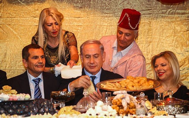 Prime Minister Benjamin Netanyahu, center, and his wife Sara attend the Jewish Moroccan celebration of Maimouna, in Or Akiva on April 21, 2014. (photo credit: Avishag Shaar Yashuv/Flash90/Pool) Prime Minister Benjamin Netanyahu, center, and his wife Sara attend the Jewish Moroccan celebration of Maimouna, in Or Akiva on April 21, 2014. (photo credit: Avishag Shaar Yashuv/Flash90/Pool)
