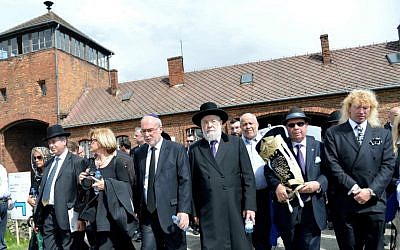 The Israeli delegation, led by Rabbi Meir Lau and chief justice of the Supreme Court Asher Gronis, walk through the entrance of Auschwitz death camp in Poland, as they participate in the March of the Living on April 28, 2014. (photo credit: Yossi Zeliger/FLASH90)