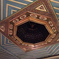 The hand-painted wooden ceiling of the hotel's Pasha Room had to have an unexploded bomb removed from its roof following the 1967 Six-Day War. (photo credit: Jessica Steinberg/Times of Israel)