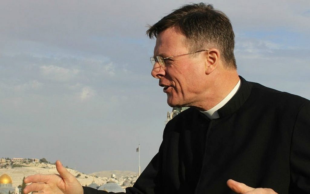 Father Eamon Kelly points out the biblical significance of areas in the Old City during a tour preceding Holy Week (photo credit: Rebecca McKinsey/Times of Israel) Father Eamon Kelly points out the biblical significance of areas in the Old City during a tour preceding Holy Week (photo credit: Rebecca McKinsey/Times of Israel)
