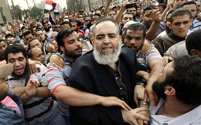Egyptian Muslim cleric and candidate for the Egyptian presidency Hazem Salah Abu-Ismail, center, is guarded by his supporters as he enters Tahrir Square during a protest against the ruling military council, in Cairo, Egypt,Oct. 28, 2011. (photo credit: AP/Amr Nabil) Egyptian Muslim cleric and candidate for the Egyptian presidency Hazem Salah Abu-Ismail, center, is guarded by his supporters as he enters Tahrir Square during a protest against the ruling military council, in Cairo, Egypt,Oct. 28, 2011. (photo credit: AP/Amr Nabil)