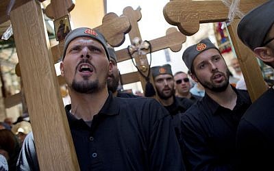 Serbian pilgrims carry crosses during Good Friday in Jerusalem on Friday, April 18, 2014, as Christians commemorated the crucifixion of Jesus. (photo credit: AP/Dusan Vranic)