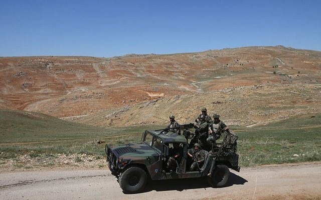 In this picture taken on Tuesday, April 22, 2014, Lebanese army soldiers patrol a road near Ras al-Haref mountain at the unmarked Lebanese-Syrian border, eastern Lebanon. (photo credit: AP/Hussein Malla) In this picture taken on Tuesday, April 22, 2014, Lebanese army soldiers patrol a road near Ras al-Haref mountain at the unmarked Lebanese-Syrian border, eastern Lebanon. (photo credit: AP/Hussein Malla)