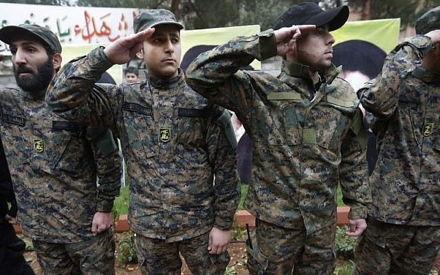 Hezbollah fighters salute during the funeral procession of Hassan al-Laqis, a senior commander of Hezbollah, who was gunned down at his hometown in Baalbek, Lebanon, on December 4, 2013, (photo credit: AP/Hussein Malla) Hezbollah fighters salute during the funeral procession of Hassan al-Laqis, a senior commander of Hezbollah, who was gunned down at his hometown in Baalbek, Lebanon, on December 4, 2013, (photo credit: AP/Hussein Malla)