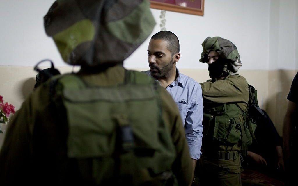 American director James Adolphus directs actors dressed in Israeli army uniforms at the filming location of his movie in the West Bank city of Nablus. (photo credit: AP/The Warren Film) American director James Adolphus directs actors dressed in Israeli army uniforms at the filming location of his movie in the West Bank city of Nablus. (photo credit: AP/The Warren Film)
