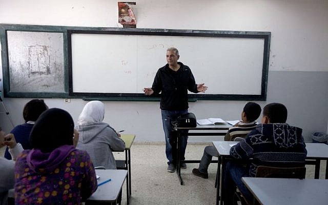 Palestinian Esmat Mansour, a former prisoner who was released after 20 years in Israeli jail, teaches Hebrew to students at a school in the village of Taybeh, near the West Bank city of Ramallah, April 3, 2014. AP/Majdi Mohammed) Palestinian Esmat Mansour, a former prisoner who was released after 20 years in Israeli jail, teaches Hebrew to students at a school in the village of Taybeh, near the West Bank city of Ramallah, April 3, 2014. AP/Majdi Mohammed)