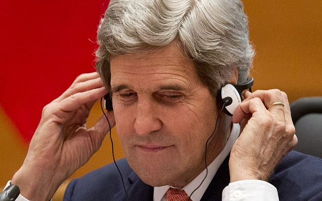 John Kerry puts on translation headphones while attending a US-Morocco Strategic Dialogue opening plenary session at the Ministry of Foreign Affairs in Rabat, Morocco Friday April 4, 2014. (photo credit: AP/Jacquelyn Martin, Pool)