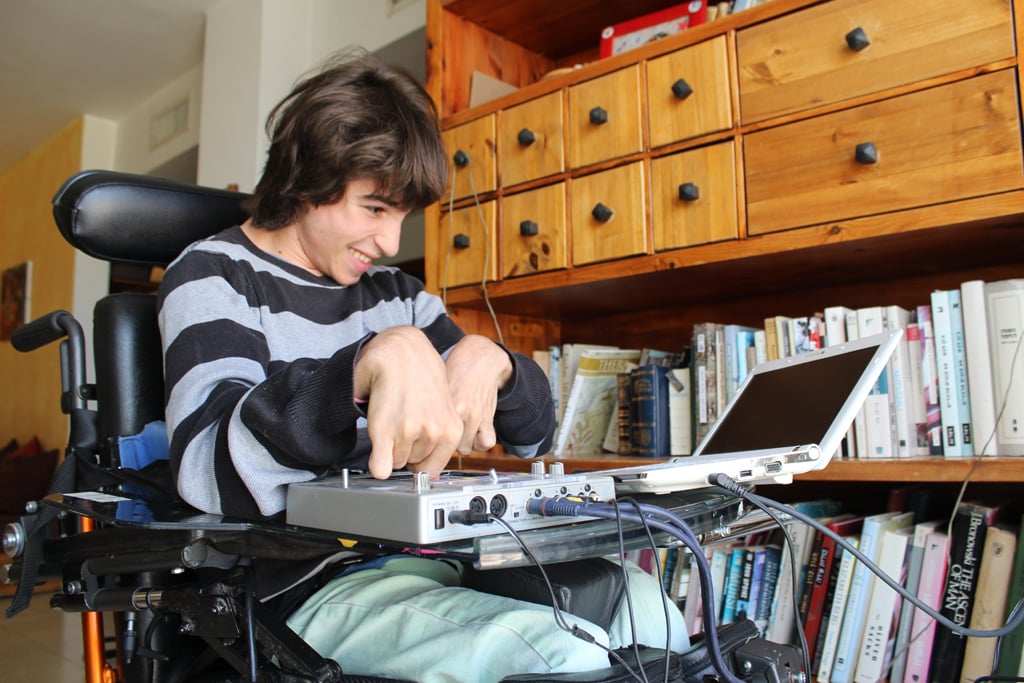 Rotem Elnatan, 19 — the inspiration for Debby Elnatan's product, the Upsee — spins tunes in his home. The teenager enjoys DJing at school parties. (The Times of Israel/Rebecca McKinsey)