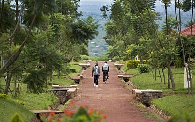 In this photo taken Monday, March 24, 2014, a Rwandan student walks in the grounds of the Agahozo-Shalom Youth Village near Rwamagana, in Rwanda. (AP Photo/Ben Curtis)