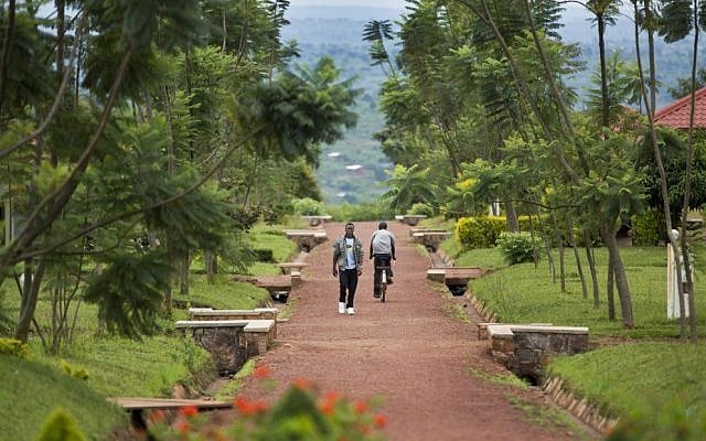 In this photo taken Monday, March 24, 2014, a Rwandan student walks in the grounds of the Agahozo-Shalom Youth Village near Rwamagana, in Rwanda. (AP Photo/Ben Curtis)