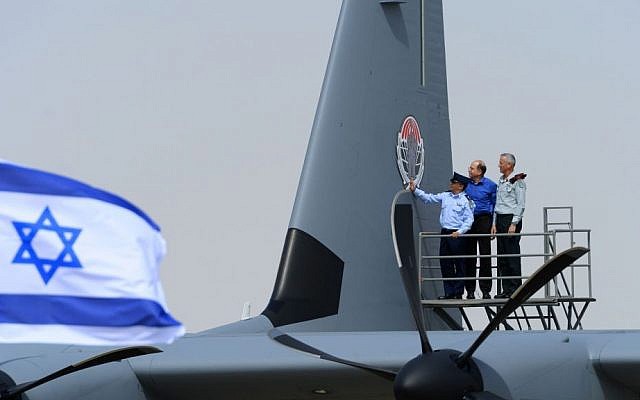 IDF chief Benny Gantz, right, and Defense Minister Moshe Ya'alon, center, along with another official, inspect the IAFs new Super Hercules aircraft, on April 9, 2014. (photo credit: courtesy IDF)