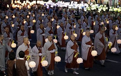 South Korean Buddhist monks carry lanterns in a parade for cherishing the memory of deceased persons and safe return of passengers aboard the sunken ferry boat Sewol on a street in Seoul, South Korea, Saturday, April 26, 2014. (photo credit: AP/Lee Jin-man)