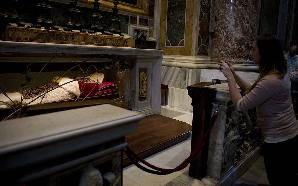A woman takes pictures of the tomb of Pope John XXIII in St. Peter's Basilica at the Vatican, Thursday, April 24, 2014. Hundreds of thousands of pilgrims and faithful are expected to reach Rome to attend the scheduled April 27 ceremony at the Vatican in which Pope Francis will elevate in a solemn ceremony John XXIII and John Paul II to sainthood. (photo credit: AP Photo/Alessandra Tarantino) A woman takes pictures of the tomb of Pope John XXIII in St. Peter's Basilica at the Vatican, Thursday, April 24, 2014. Hundreds of thousands of pilgrims and faithful are expected to reach Rome to attend the scheduled April 27 ceremony at the Vatican in which Pope Francis will elevate in a solemn ceremony John XXIII and John Paul II to sainthood. (photo credit: AP Photo/Alessandra Tarantino)