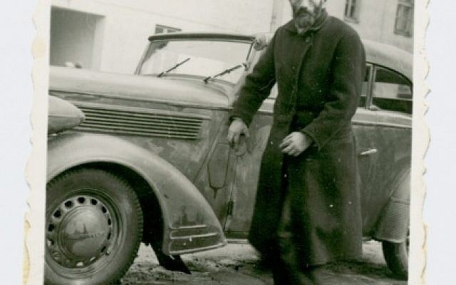 A Jewish man, forced to wash cars, looks at the photographer, Poland. (photo credit: Shem Olam Institute)