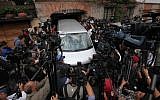 A vehicle from a funeral home is surrounded by journalists as it enters the home of the late Colombian Nobel laureate Gabriel Garcia Marquez in Mexico City, on Thursday, April 17, 2014. (photo credit: AP/Marco Ugarte)