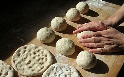 Julie Sperling working the matzah dough at the Naga Bakehouse in Vermont. (Courtesy Naga Bakehouse via JTA)