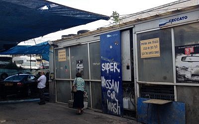 Hassan's Car Wash, depicted here as Super Hassan Car Wash, was full of action in the days before Passover (photo credit: Mitch Ginsburg/ Times of Israel)