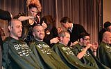 An assembly line of rabbis get their heads shaved at the CCAR convention in Chicago. (photo credit: JTA/Julie Pelc Adler)