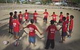 Children in the Philippine island of Bantayan play soccer with Israeli instructors from the Mifalot organization (Photo credit: Youtube screen capture)