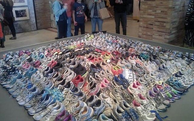 Running shoes left by last year's Boston Marathon runners at makeshift memorials, currently on display at the Boston Public Library (photo credit: Matt Lebovic)