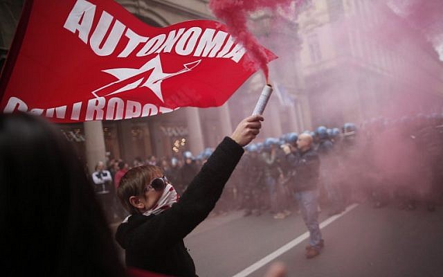 Anti-riot policemen face demonstrators in Turin during one of several rallies against unemployment and austerity in Italy for May Day, on May 1, 2014. (AFP/Marco Bertorello) 