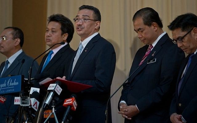 Malaysian Minister of Defence and Acting Transport Minister Hishammuddin Hussein (C) speaks during a press conference on the missing Malaysia Airlines flight MH370 in Kuala Lumpur on May 15, 2014, the day the hunt for the missing passenger jet in the Indian Ocean was put on hold. (photo credit: AFP Photo/Mohd Rasfan) Malaysian Minister of Defence and Acting Transport Minister Hishammuddin Hussein (C) speaks during a press conference on the missing Malaysia Airlines flight MH370 in Kuala Lumpur on May 15, 2014, the day the hunt for the missing passenger jet in the Indian Ocean was put on hold. (photo credit: AFP Photo/Mohd Rasfan)