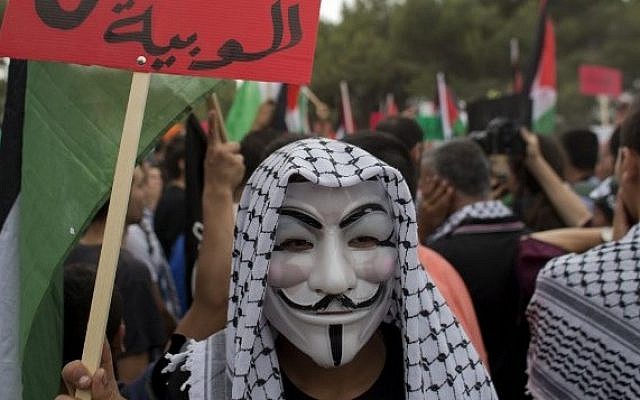 An Arab Israeli wearing a Guy Fawkes mask takes part in "The March of Return," May 6, 2014 (Photo credit: Ahmad Gharabli/AFP) An Arab Israeli wearing a Guy Fawkes mask takes part in "The March of Return," May 6, 2014 (Photo credit: Ahmad Gharabli/AFP)